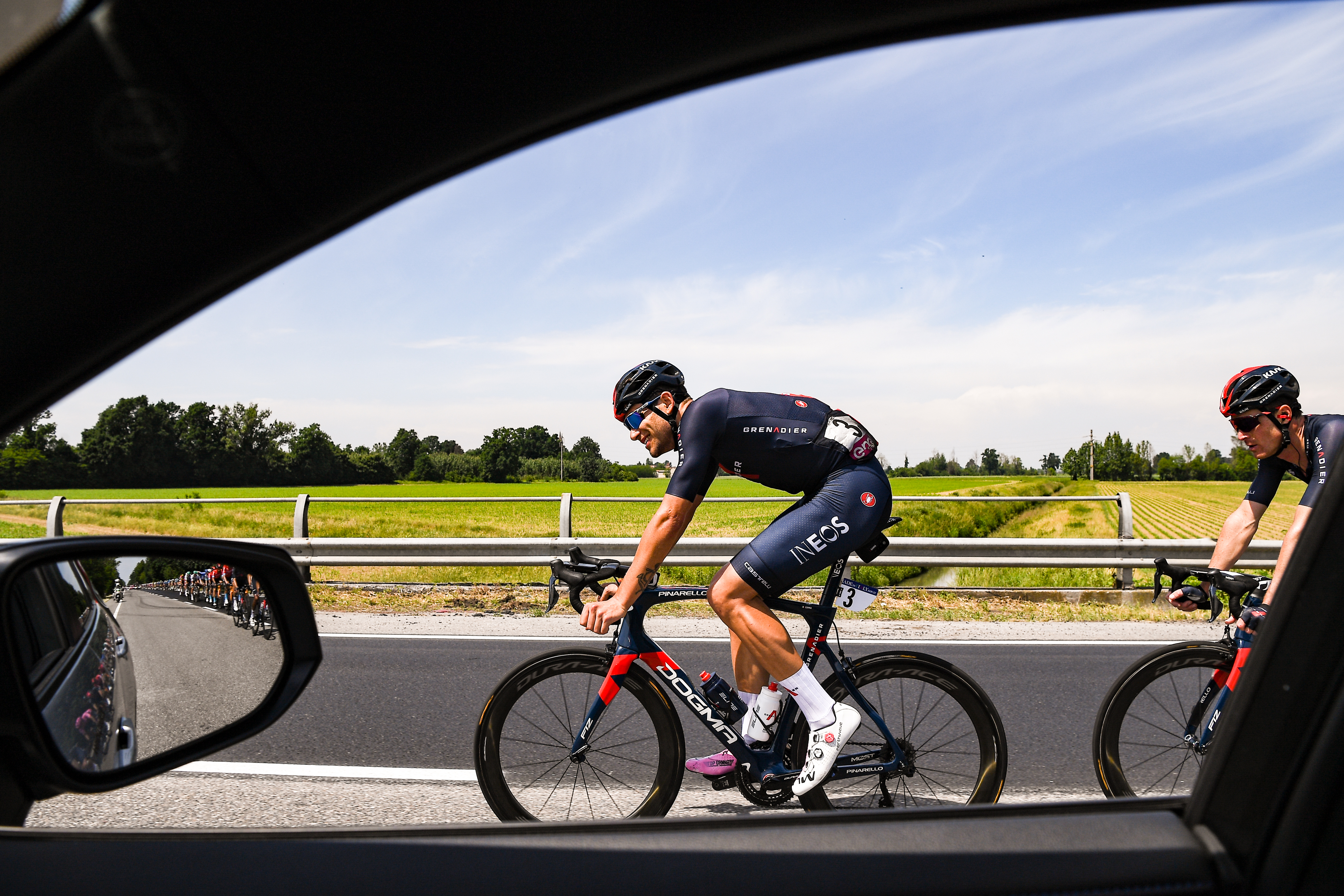 An Ineos Grenadier cyclist photographed from an in-car hospitality vehicle