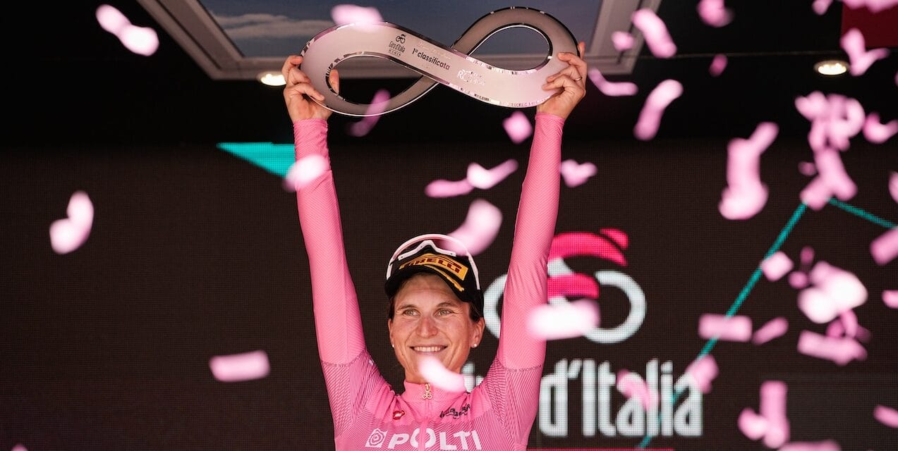A rider poses with the trophy at the finish of the Giro d'Italia Women's race