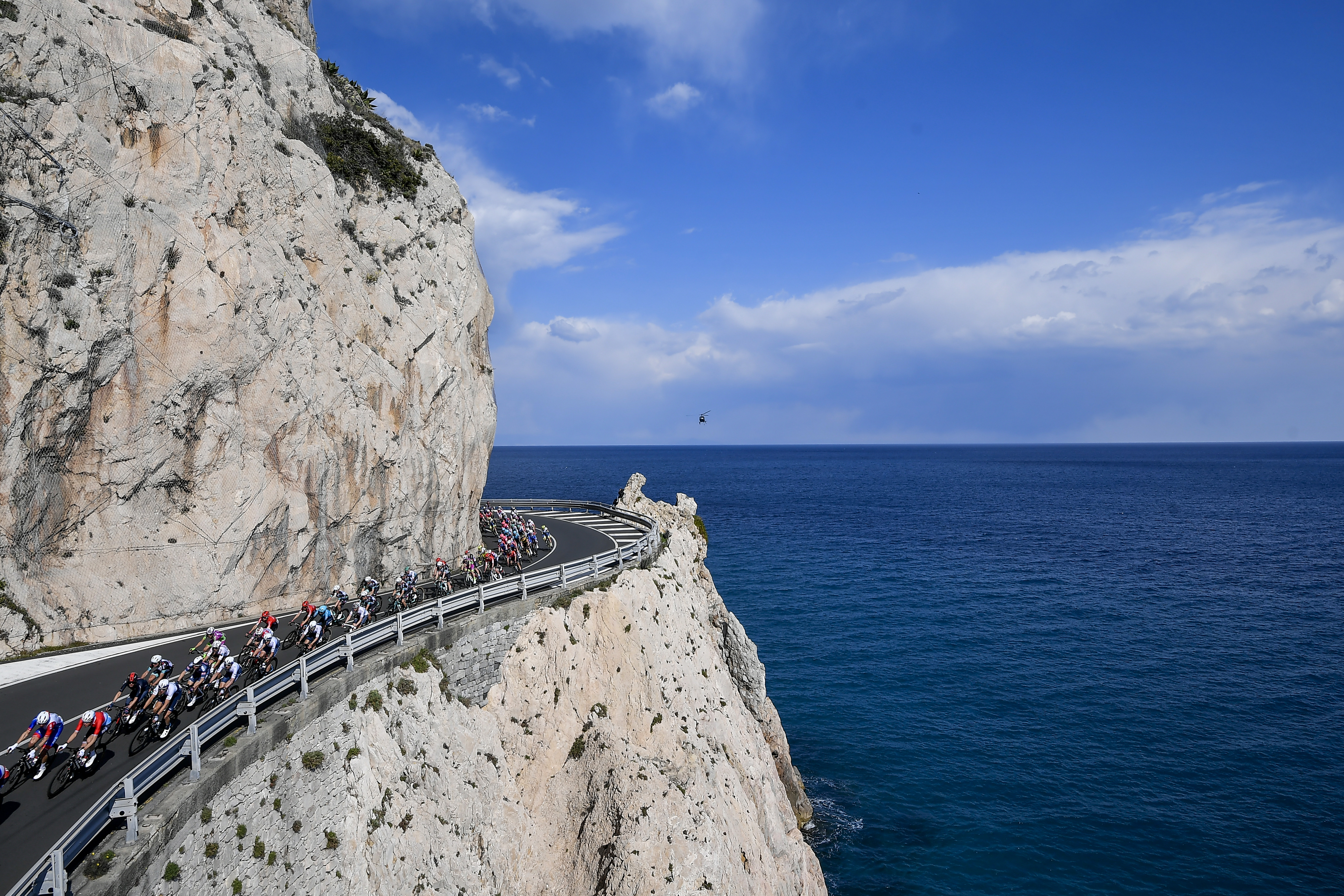 Riders tackle a tricky cliffside hairpin during the Milan Sanremo