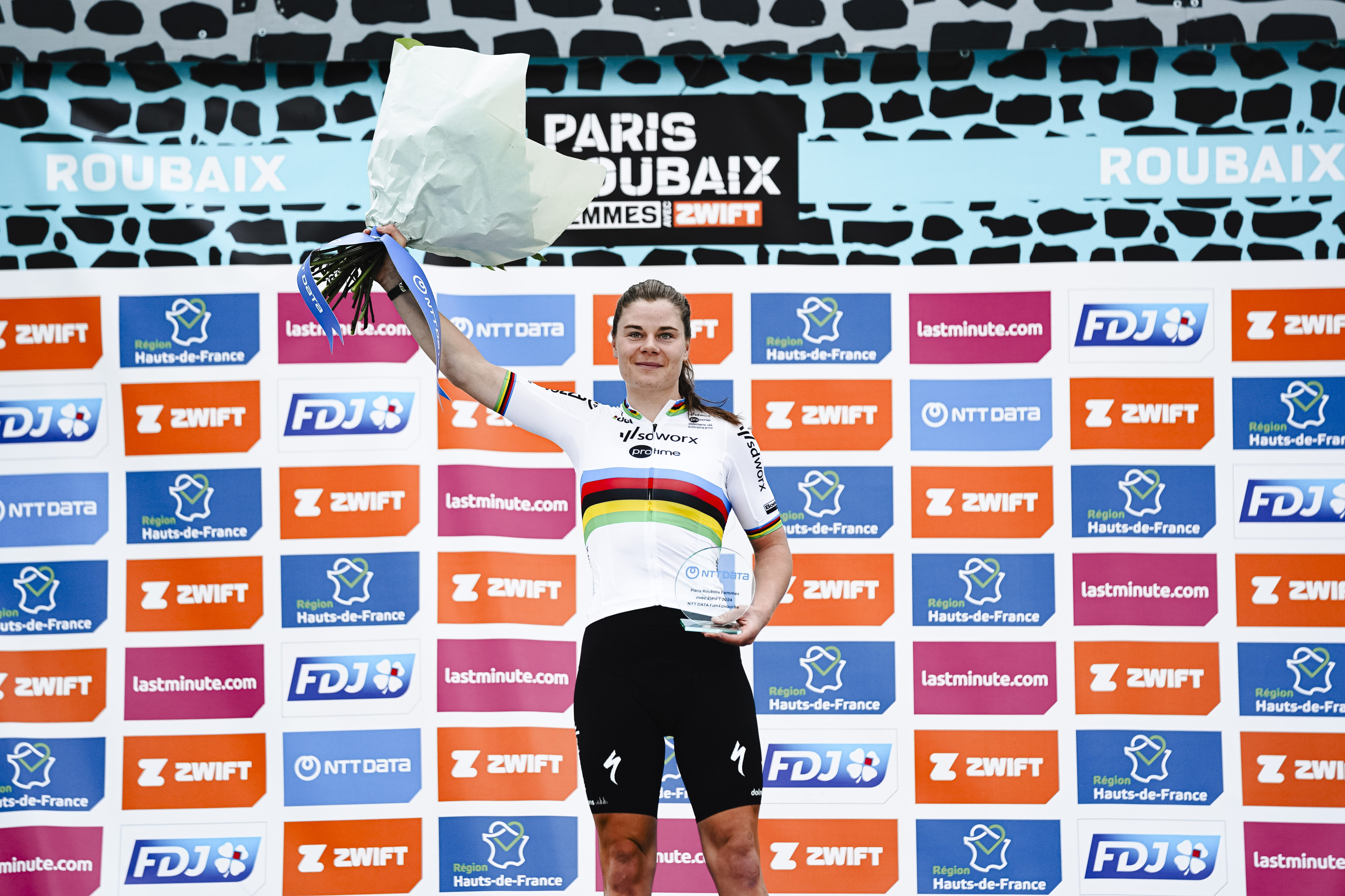 A female rider celebrates at the finish line of the Spring Classics trip