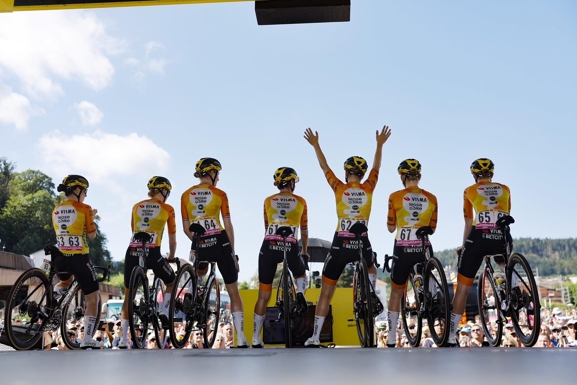 A group of riders celebrate on the podium during the Etape du Tour Femme