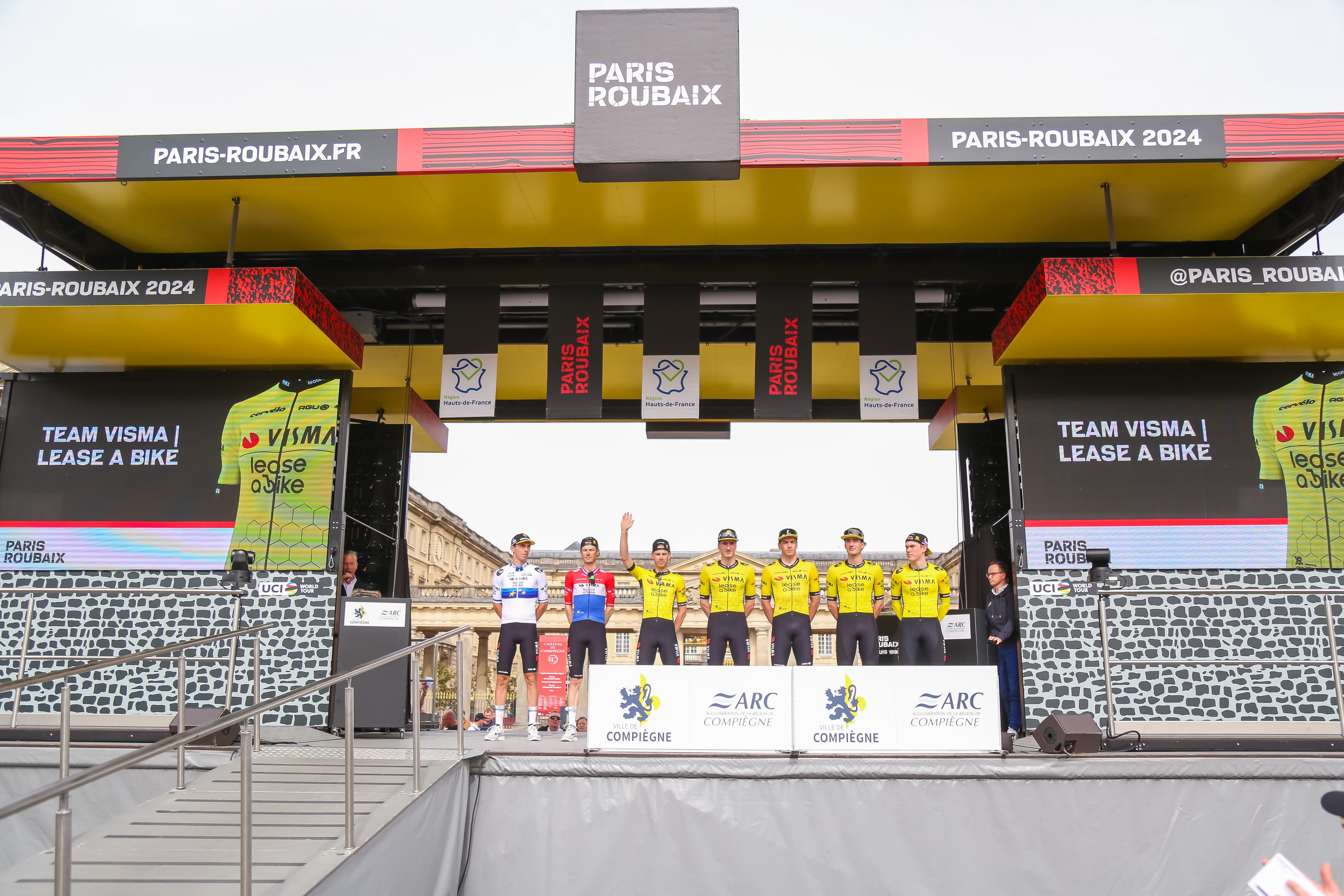 Riders pose at the end of Paris Roubaix 2025
