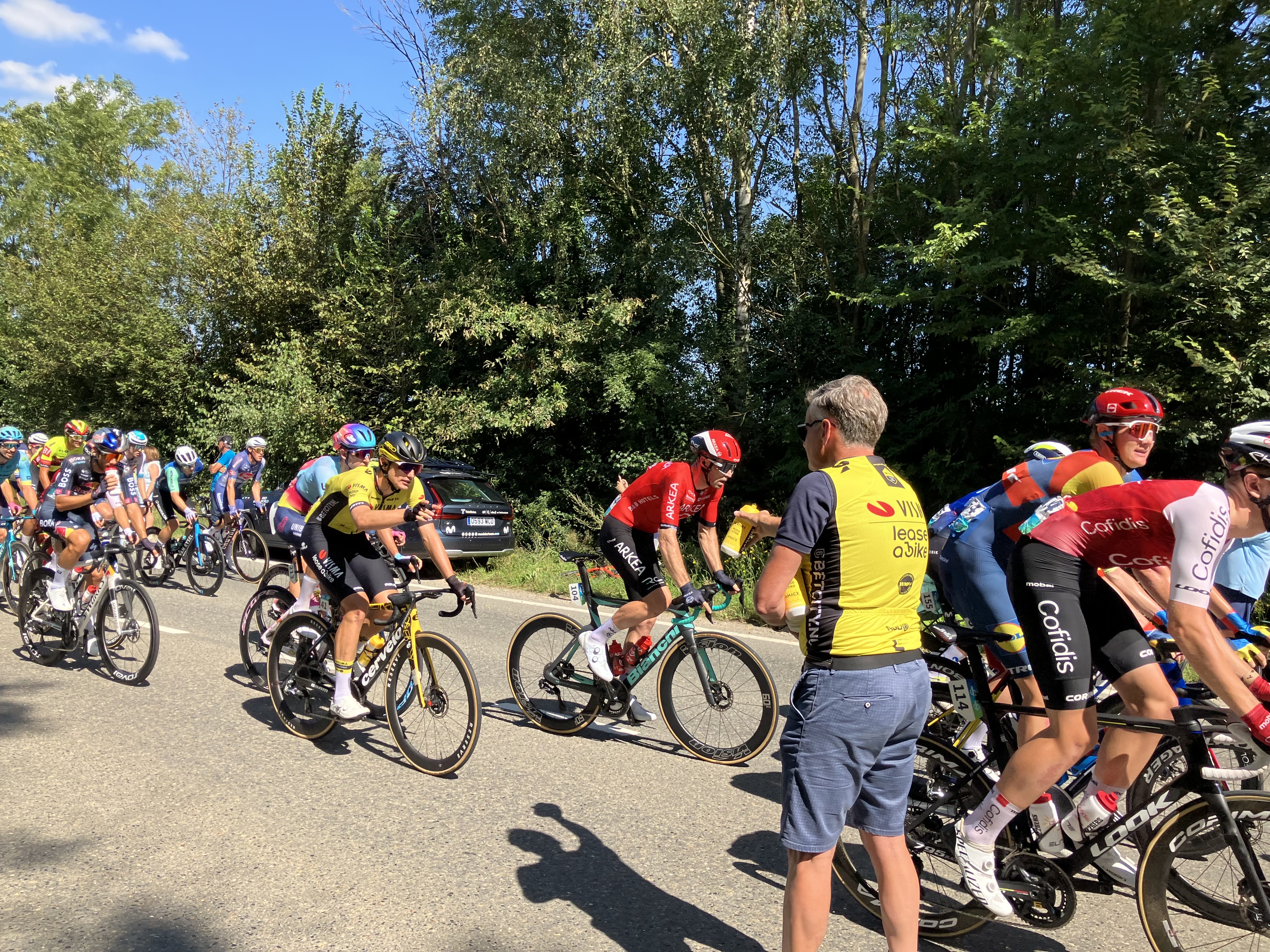 Team Visma Lease a Bike experience spectators hand out water bottles during the Renewi Tour