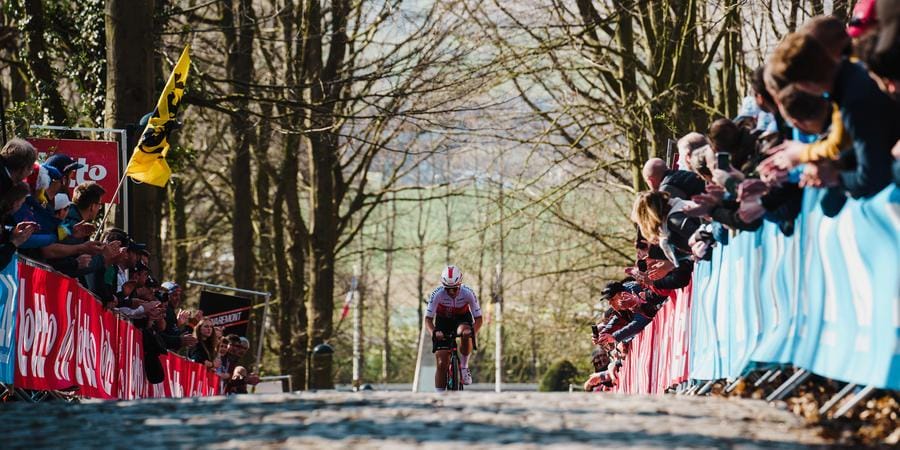 A rider battles up a short cobbled hill during the Tour of Flanders