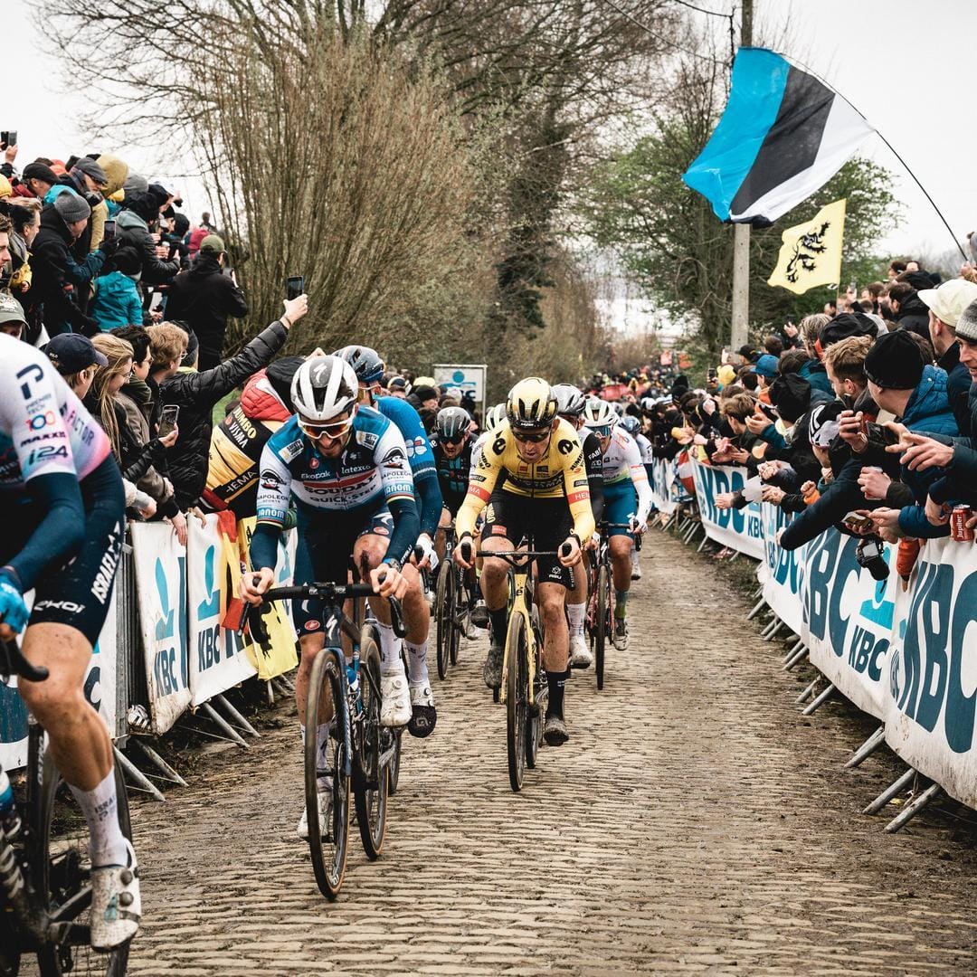 Spectators cheer on riders on the final straight of the Tour of Flanders