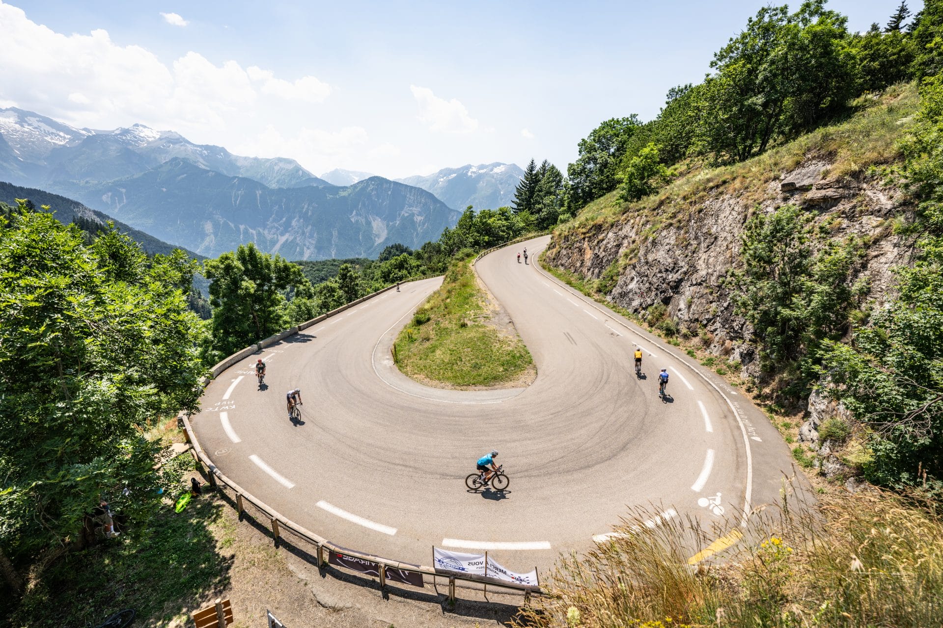 Cyclists tackle a hairpin bend, luckily on the ascent, during the Route des Grandes Alpes